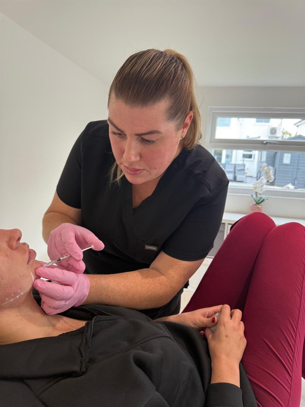 Stacey Cort performing an injectable treatment in her clinic